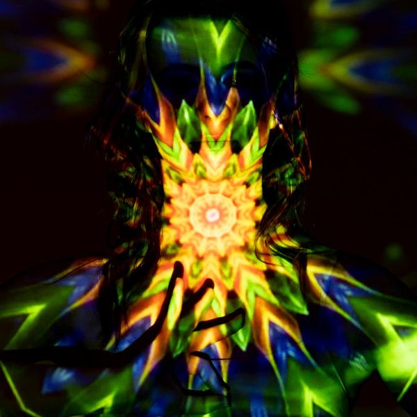 Silhouette of a person meditating with a glowing energy aura.